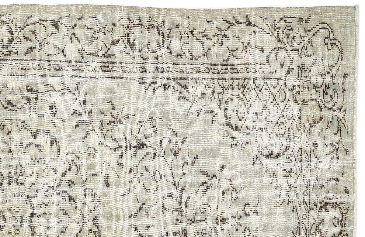 Beige and brown vintage-style rug with a distressed floral medallion pattern on a white background.