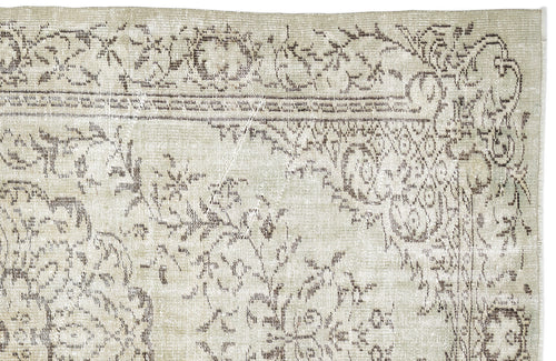Load image 1 in gallery view. Beige and brown vintage-style rug with a distressed floral medallion pattern on a white background.