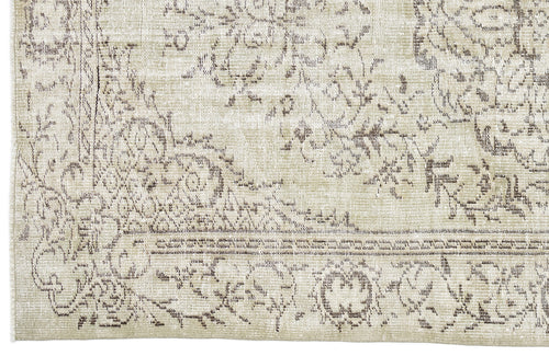 Load image 1 in gallery view. Beige and taupe vintage-style rug with a distressed, faded floral medallion pattern and a decorative border.