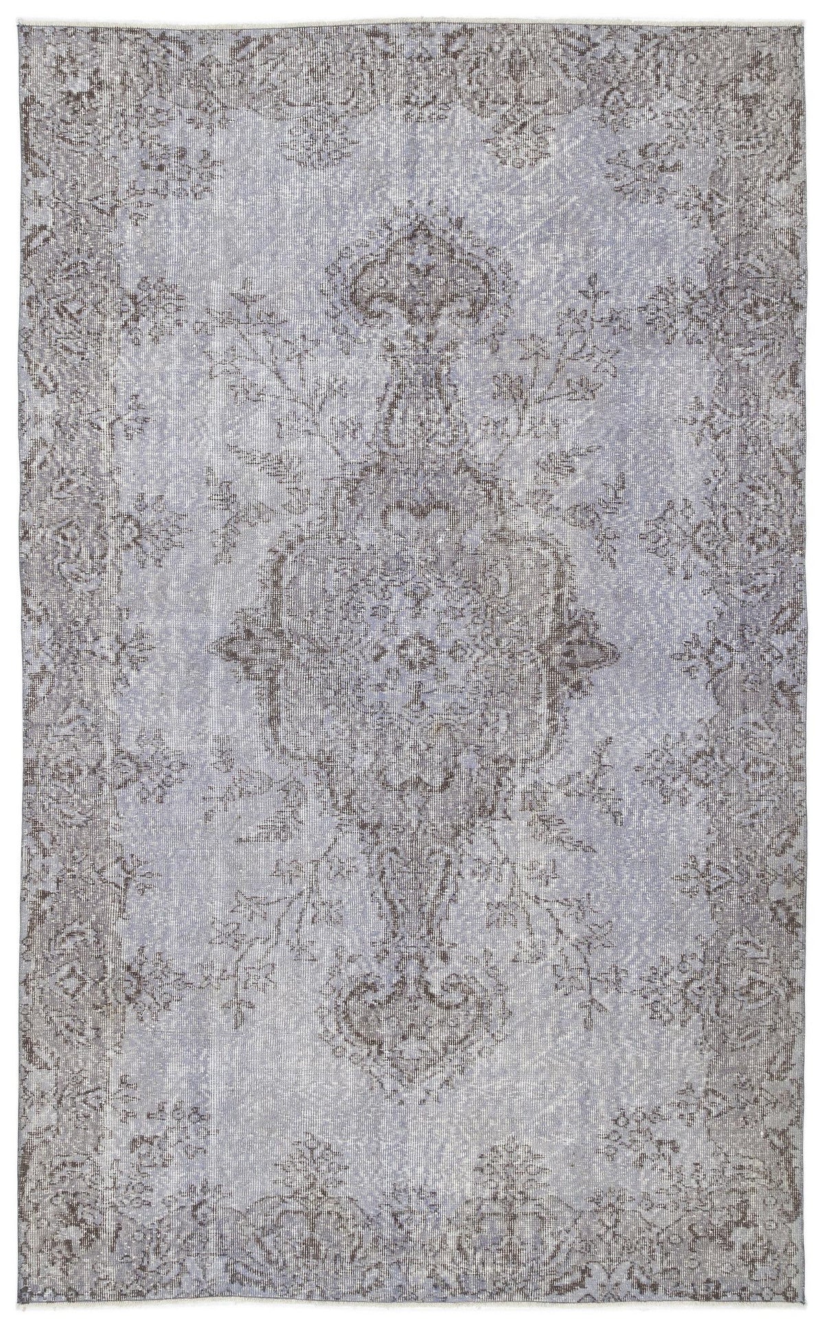 Light blue and grey distressed rug with a traditional central medallion and ornate floral border.