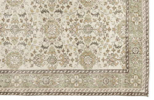 Load image 1 in gallery view. The Nizora - Vintage Floral Rug (6'1 x 10'0) features an ornate, symmetrical floral and geometric design in muted beige, cream, green, and brown tones with a detailed border along the right and bottom edges.