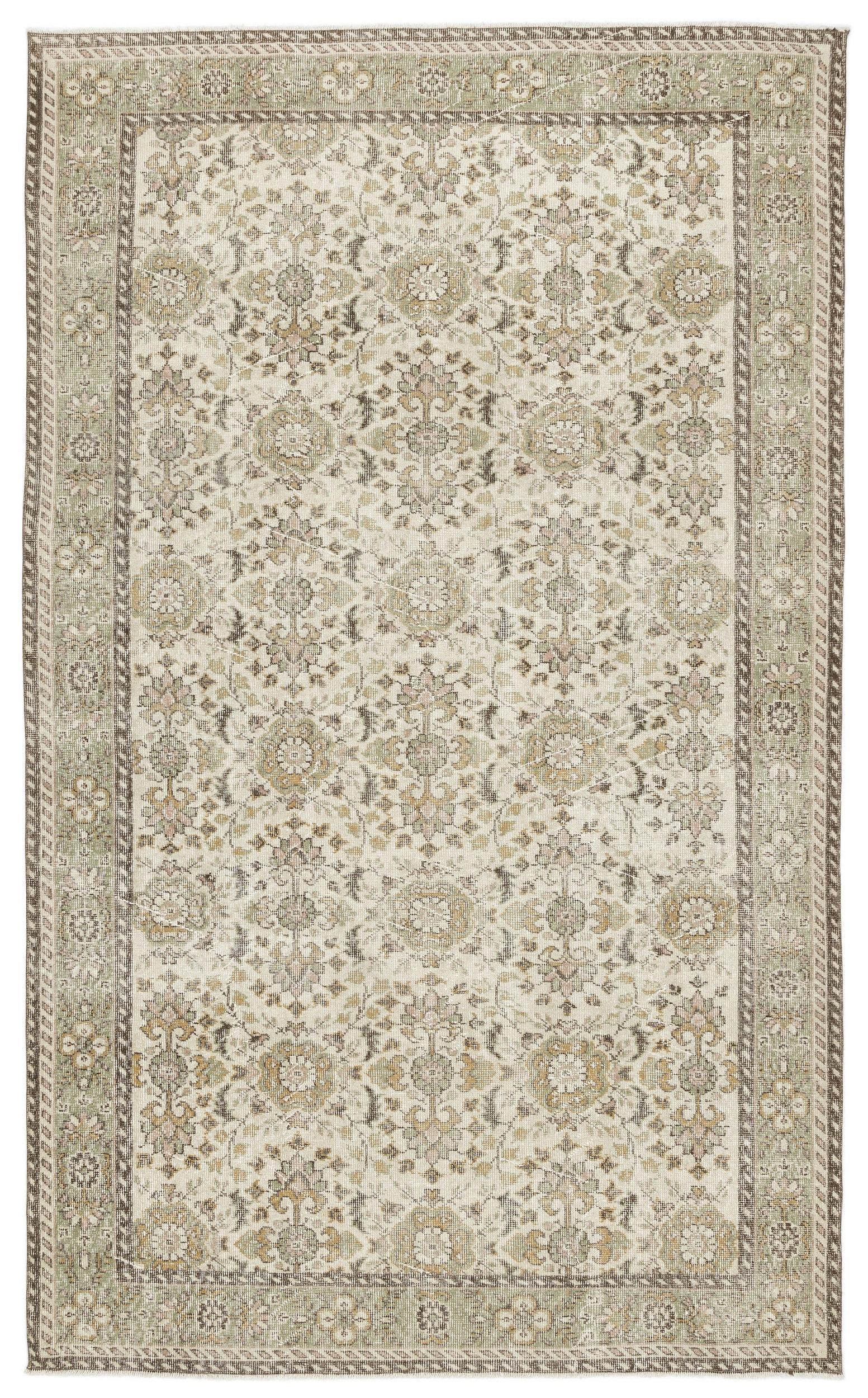 The Nizora Vintage Floral Rug (6'1" x 10'0) features an intricate, symmetrical floral and vine pattern in muted beige, cream, and sage green with decorative borders for a timeless, elegant look.