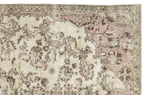 Load image 1 in gallery view. Distressed vintage-style rug with a faded floral medallion pattern in muted pink, beige, and brown tones.