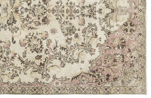 Load image 1 in gallery view. Distressed beige, brown, and dusty pink rug with a traditional floral medallion pattern and a detailed border.