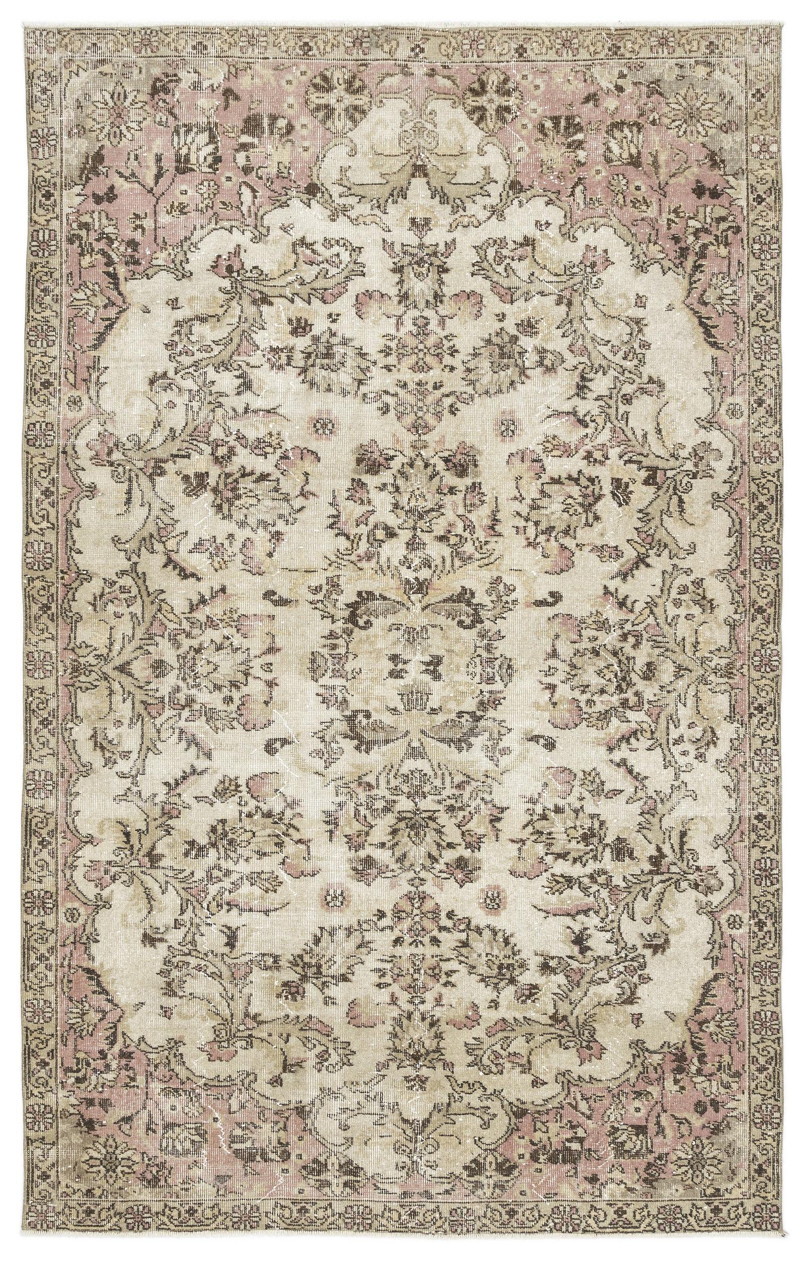 Distressed beige and dusty pink traditional rug with a central floral medallion and ornate border.