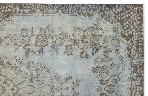 Load image 1 in gallery view. Distressed light blue and brown rug with a traditional floral medallion pattern and ornate border.