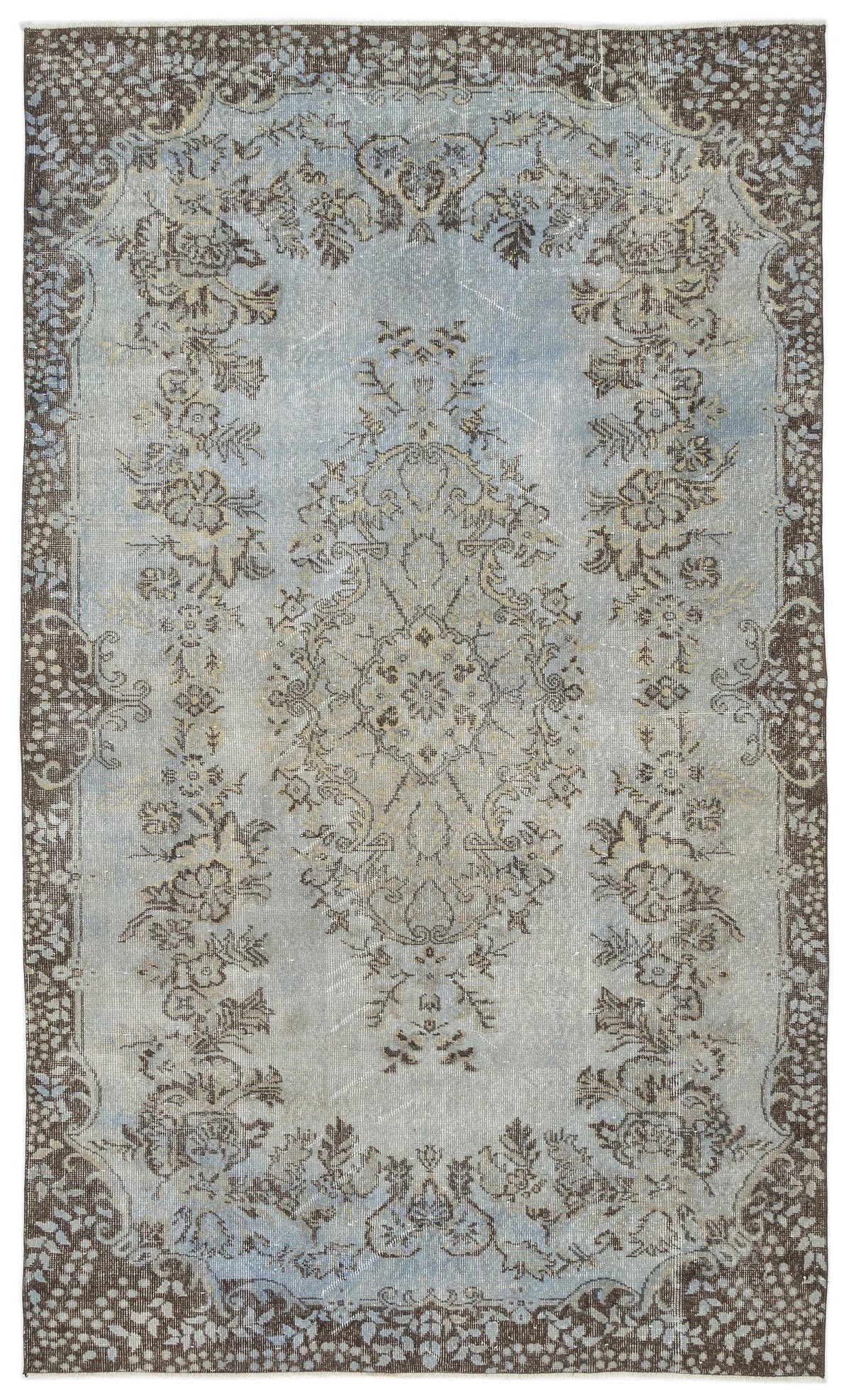 Distressed light blue and brown rug with a central floral medallion and ornate border pattern.