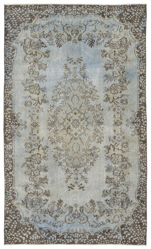 Load image 1 in gallery view. Distressed light blue and brown rug with a central floral medallion and ornate border pattern.