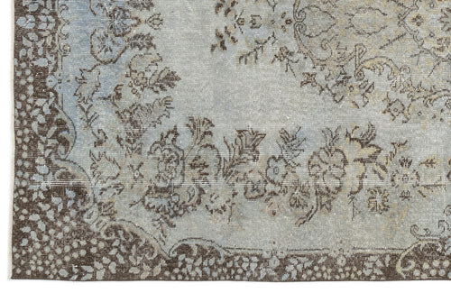 Load image 1 in gallery view. Light blue and brown rug with a distressed floral medallion pattern and a dark border.