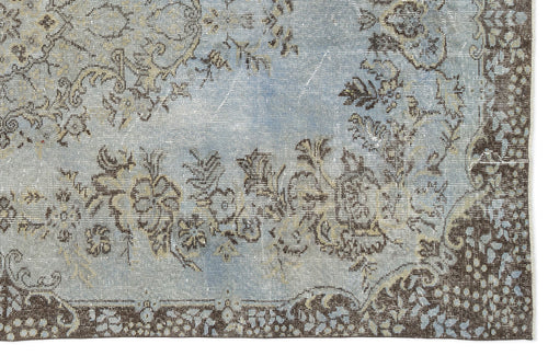 Load image 1 in gallery view. Light blue and brown distressed rug with a traditional floral medallion pattern and ornate border.