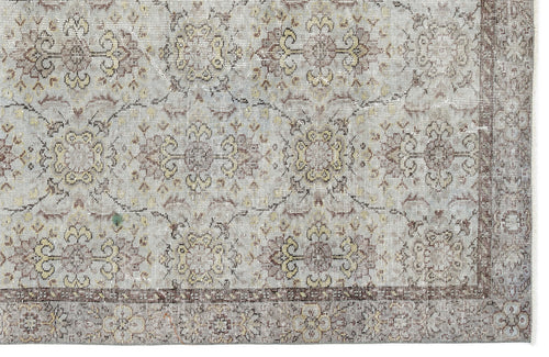 Load image 1 in gallery view. Light gray rug with a distressed floral medallion pattern in muted brown and yellow, featuring a dark border.