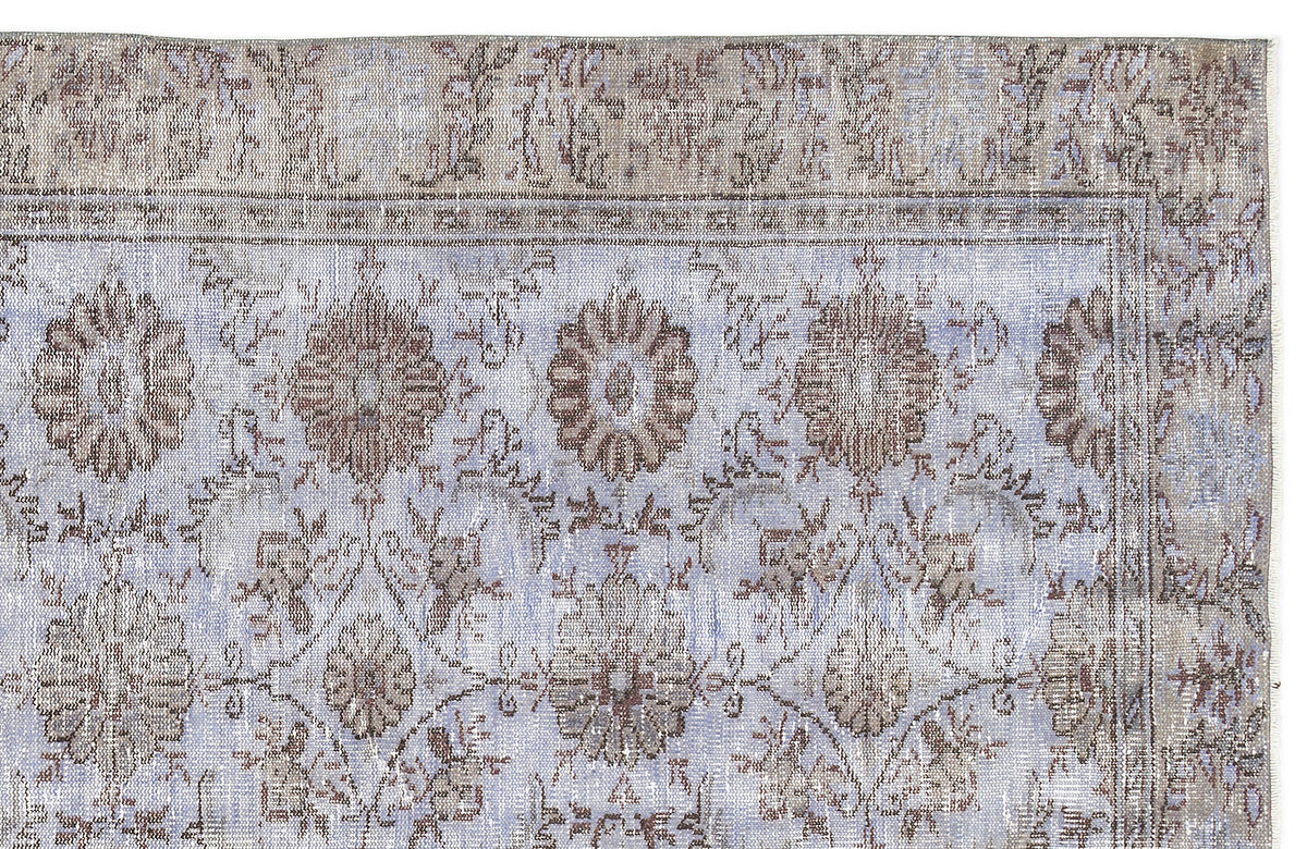Light blue and taupe vintage-style rug with a distressed floral medallion pattern and a wide decorative border.