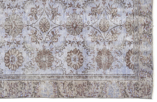 Load image 1 in gallery view. Light blue and taupe distressed rug with a traditional floral medallion pattern and a wide decorative border.