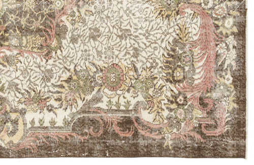 Load image 1 in gallery view. Distressed brown, cream, and muted pink rug with a traditional floral medallion pattern and a wide border.