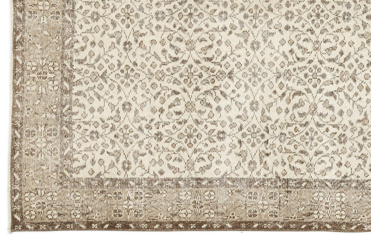 Beige and cream rug with a distressed traditional floral medallion pattern and a wide decorative border.
