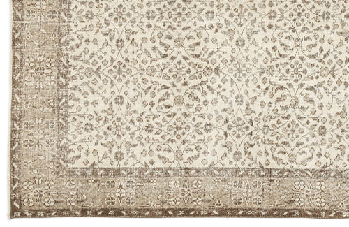 Load image 1 in gallery view. Beige and cream rug with a distressed traditional floral medallion pattern and a wide decorative border.