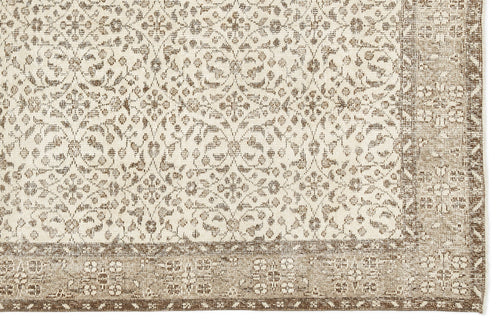 Load image 1 in gallery view. Beige and cream rug with a distressed floral medallion pattern and a wide, detailed border.
