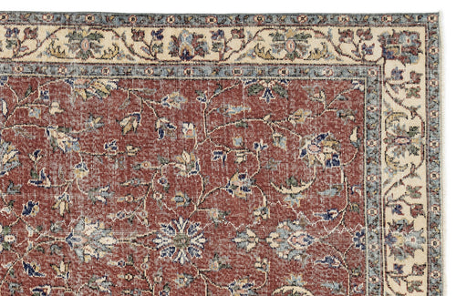 Load image 1 in gallery view. Terracotta traditional rug with a floral vine pattern, cream and blue borders, and a distressed finish.