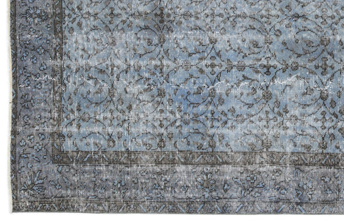 Load image 1 in gallery view. Blue and charcoal grey distressed rug with a traditional floral vine pattern and a wide geometric border.