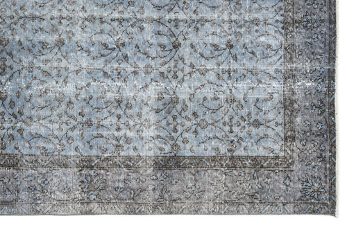 Load image 1 in gallery view. Distressed blue and charcoal grey rug with a traditional floral medallion pattern and a wide decorative border.