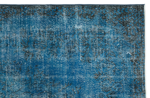 Load image 1 in gallery view. Deep blue and black distressed rug with a faded traditional floral pattern on a white background.