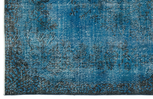 Load image 1 in gallery view. Teal and black distressed rug with a faded floral pattern and a dark border.