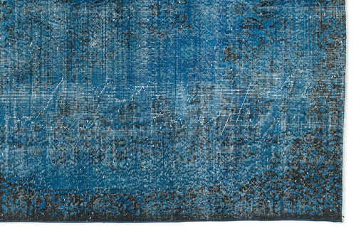 Load image 1 in gallery view. Deep blue distressed rug with a faded black traditional floral pattern and a solid dark border.