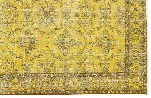 Load image 1 in gallery view. Mustard yellow and brown distressed rug with a traditional floral medallion pattern and a decorative border.