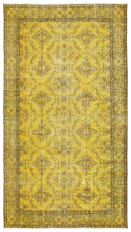 Load image 1 in gallery view. Mustard yellow and brown distressed rug with a traditional floral medallion pattern and a wide decorative border.