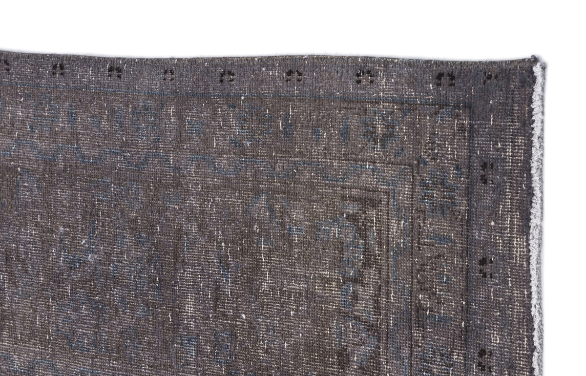 Charcoal and slate blue distressed rug with a faded traditional border pattern on a white background.