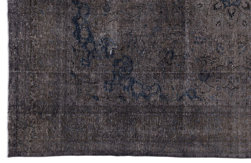 Load image 1 in gallery view. Charcoal and navy blue distressed rug with a faded traditional floral medallion pattern.