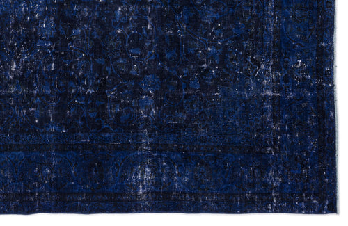 Load image 1 in gallery view. Deep blue distressed rug with a faded traditional floral medallion pattern and a dark border.