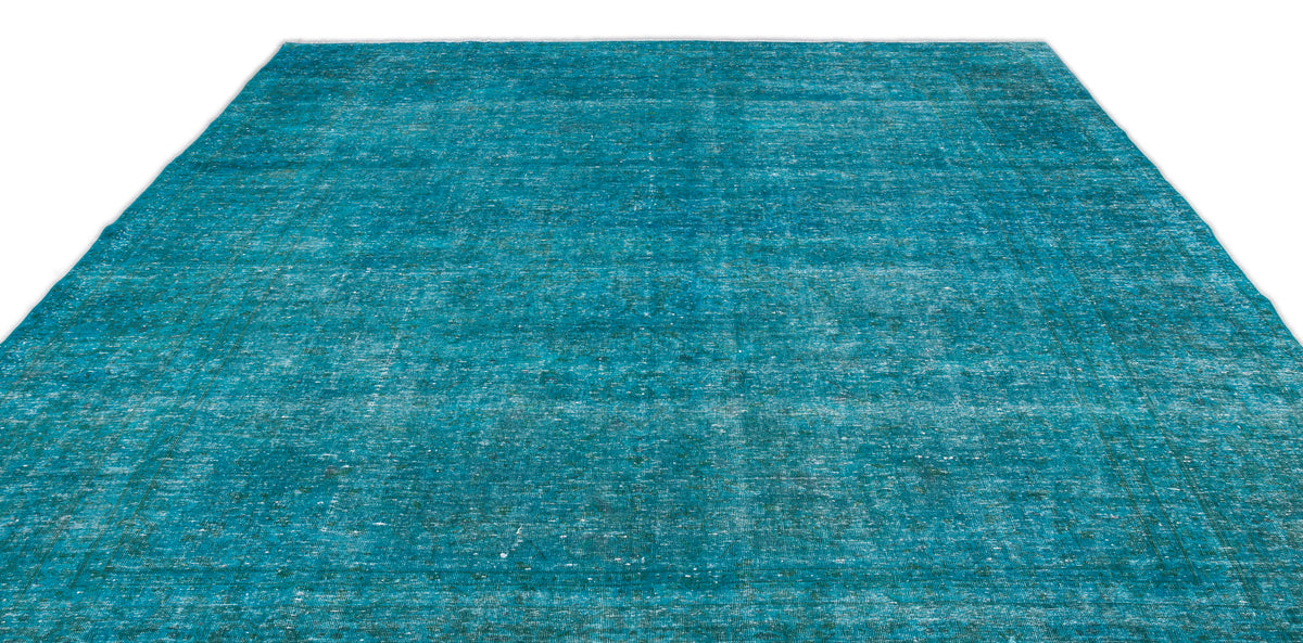 Teal distressed area rug with a faded traditional medallion pattern on a white background.