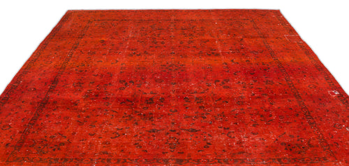 Load image 1 in gallery view. Distressed red rug with a faded black traditional floral medallion pattern and a wide border.