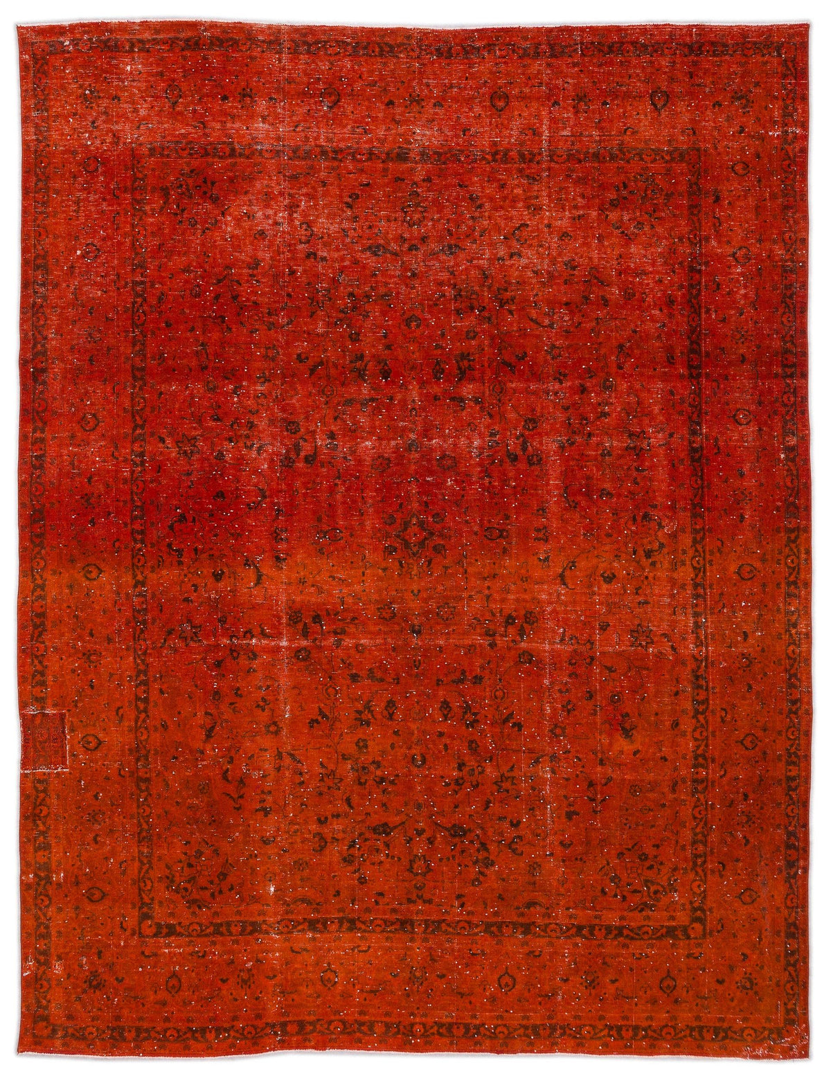 Distressed red vintage rug with a dark floral medallion pattern and a decorative border on a white background.