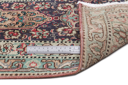 Load image 1 in gallery view. Navy, red, and sage green traditional Persian-style rug with a floral medallion pattern, shown with a measuring ruler.