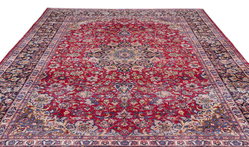 Load image 1 in gallery view. Red traditional Persian-style rug with a central floral medallion, intricate navy and cream borders, and distressed finish.
