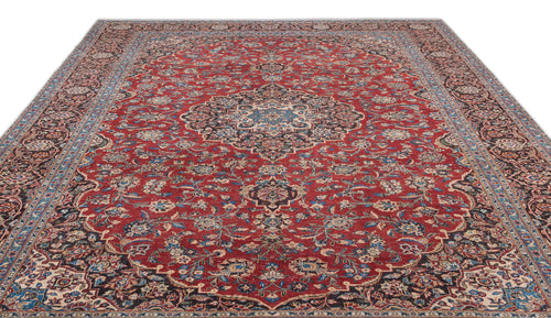 Load image 1 in gallery view. Red traditional Persian-style rug with a central floral medallion, intricate blue and cream patterns, and a wide border.