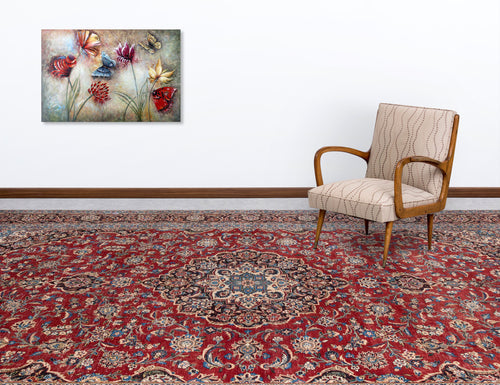 Load image 1 in gallery view. Red traditional Persian-style rug with a central floral medallion and intricate blue and cream patterns in a room setting.