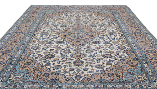 Load image 1 in gallery view. Cream, blue, and tan traditional Persian-style rug with a central floral medallion and intricate botanical border.
