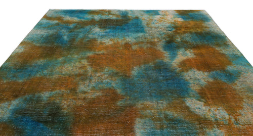 Load image 1 in gallery view. Blue and copper abstract rug with a distressed, cloud-like watercolor pattern on a white background.