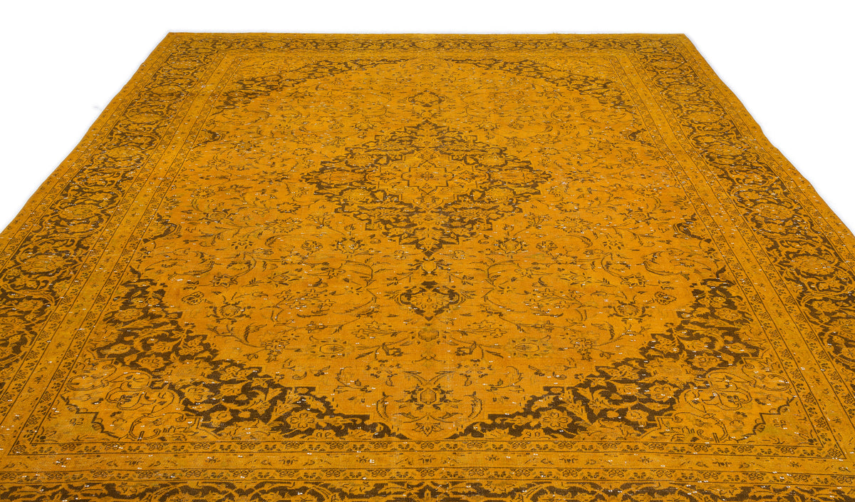 Mustard yellow traditional rug with a dark brown central medallion and intricate floral border on a white background.