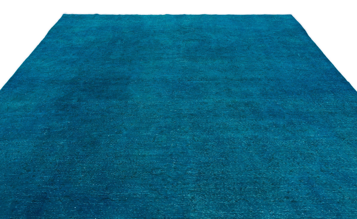 Solid teal area rug with a distressed, weathered texture on a white background.