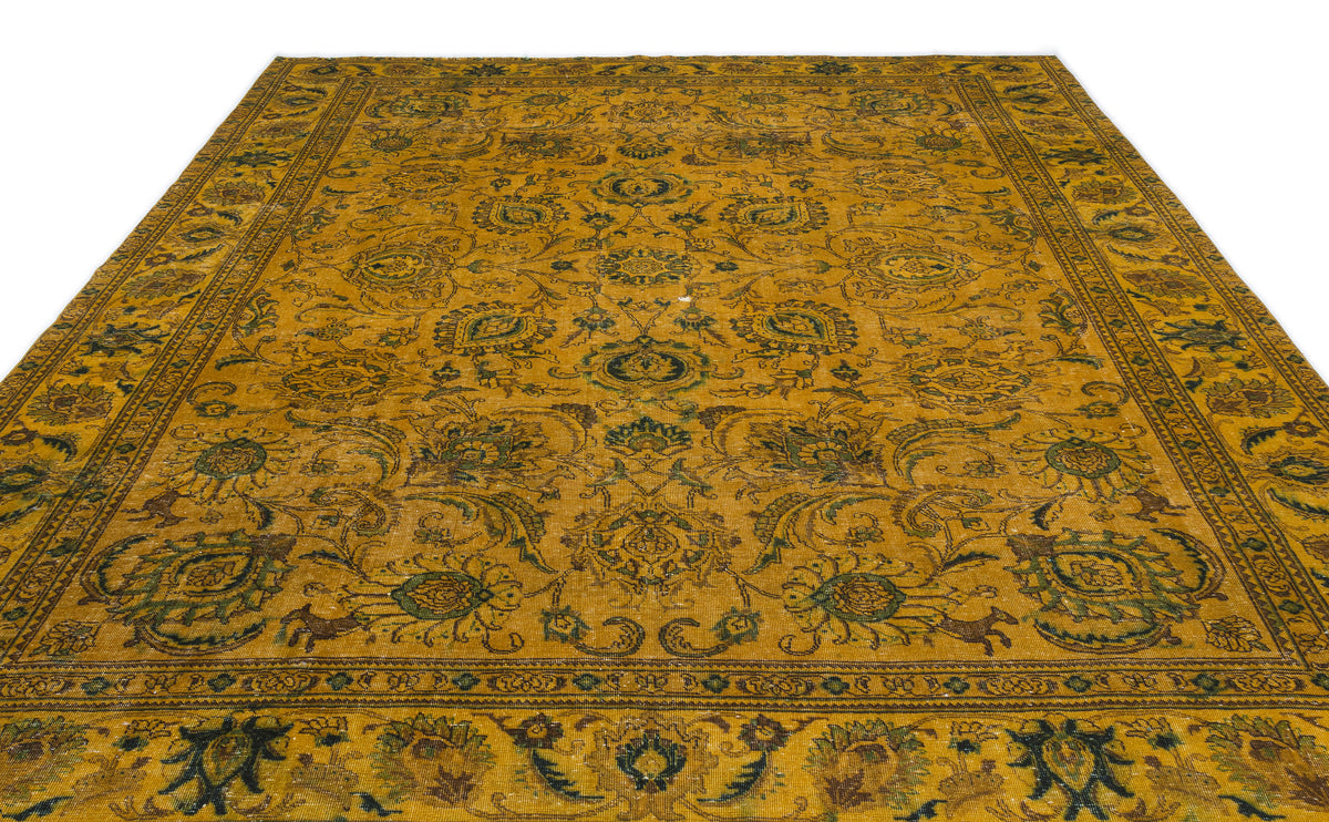 Mustard yellow vintage-style rug with a dark green and brown floral medallion pattern and a decorative border.