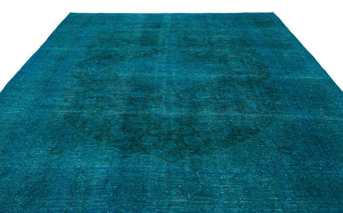 Load image 1 in gallery view. Teal distressed area rug with a subtle, faded central medallion pattern on a white background.