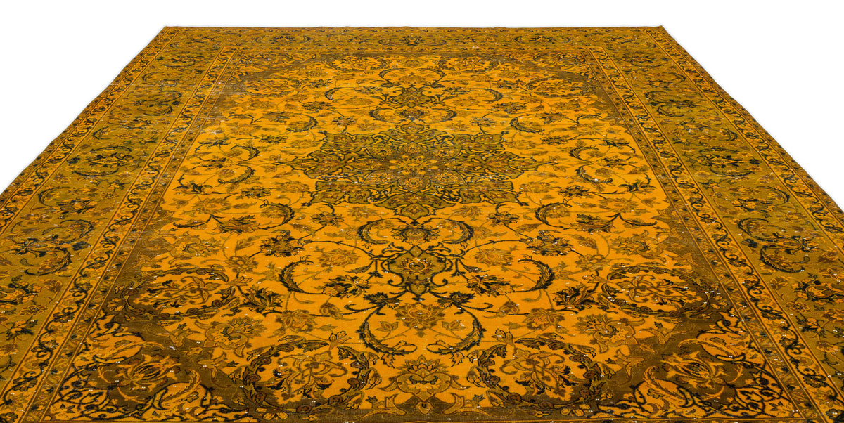 Mustard yellow and dark olive traditional rug with a central floral medallion and intricate scrolling vine border.
