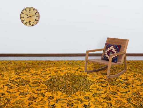 Load image 1 in gallery view. Mustard yellow rug with a dark floral medallion pattern, styled in a room with a wooden rocking chair and wall clock.