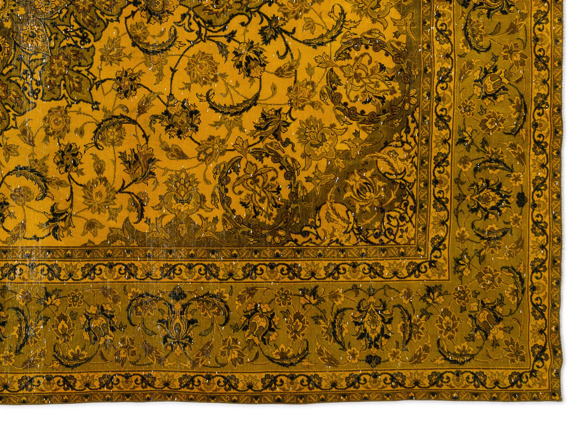 Mustard yellow and dark brown traditional rug with an intricate floral vine pattern and a decorative border.