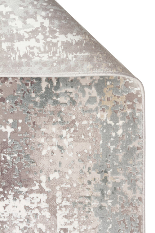 Load image 1 in gallery view. Mauve, grey, and cream area rug with a distressed, pixelated abstract pattern, shown with a corner folded over.