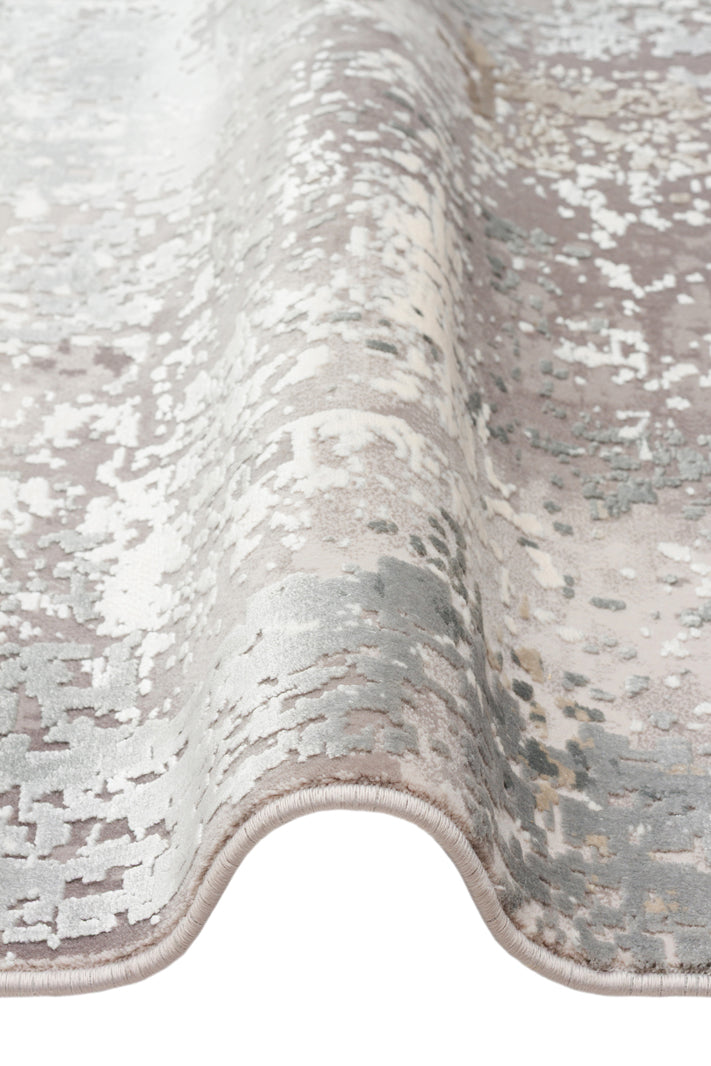 Grey and white abstract distressed pattern rug with a soft, folded texture on a white background.